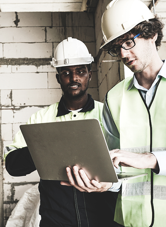 two-contractors-looking-over-blueprints-on-a-jobsite-in-connecticut